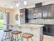 Bright kitchen featuring a granite island, stainless steel appliances, and stylish pendant lighting at 3184 Pinenut Dr, Apopka, FL 32712