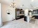 Elegant kitchen with stainless steel appliances, granite counters, dark cabinetry, and breakfast bar seating at 3184 Pinenut Dr, Apopka, FL 32712
