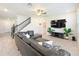 Open living room with tile floors, ceiling fan, TV, and a large comfortable couch at 3184 Pinenut Dr, Apopka, FL 32712