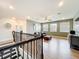 Upstairs loft area with sleek, dark brown bannister, wood floors and a sofa at 3184 Pinenut Dr, Apopka, FL 32712