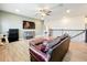 Spacious upstairs loft with wood floors, sectional seating, flat-screen TV and modern shelving at 3184 Pinenut Dr, Apopka, FL 32712