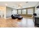 Upstairs loft area featuring wood floors, neutral walls, comfortable couch and mounted TV at 3184 Pinenut Dr, Apopka, FL 32712