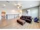 Relaxing upstairs loft featuring sleek, dark brown bannister, wood floors and modern decor at 3184 Pinenut Dr, Apopka, FL 32712