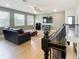 Open loft area with wood floors, dark brown couch and flat screen TV at 3184 Pinenut Dr, Apopka, FL 32712