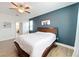Comfortable main bedroom with white linens, wood floors, and a glimpse into the ensuite bathroom at 3184 Pinenut Dr, Apopka, FL 32712