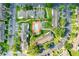Aerial view of condo community showcasing mature trees, green space, walking paths and community pool at 3249 Sandy Shore Ln, Kissimmee, FL 34743