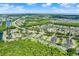 Expansive aerial view showcasing the community's lush green surroundings, nearby lakes, and well-maintained landscaping at 3249 Sandy Shore Ln, Kissimmee, FL 34743