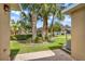 Backyard showcasing well-maintained landscaping, green grass, and palm trees, offering a serene outdoor setting at 3249 Sandy Shore Ln, Kissimmee, FL 34743