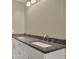 Bright bathroom featuring a double vanity with granite counters and modern fixtures at 3249 Sandy Shore Ln, Kissimmee, FL 34743