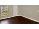 Charming bedroom featuring hardwood floors, a large window, and neutral tones for a warm, inviting space at 3249 Sandy Shore Ln, Kissimmee, FL 34743