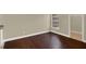 Bright bedroom with hardwood floors, a large window, and a view of the yard, providing a relaxing atmosphere at 3249 Sandy Shore Ln, Kissimmee, FL 34743