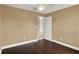 Comfortable bedroom featuring hardwood flooring, a ceiling fan, and ample natural light at 3249 Sandy Shore Ln, Kissimmee, FL 34743