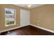Cozy bedroom with hardwood flooring, a double door closet, and a bright window with a pleasant view at 3249 Sandy Shore Ln, Kissimmee, FL 34743