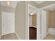 Open hallway showcasing hardwood floors leading to the bedroom and a view of the bathroom at 3249 Sandy Shore Ln, Kissimmee, FL 34743
