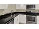 Modern kitchen featuring granite countertops, stainless steel appliances, and ample cabinet space at 3249 Sandy Shore Ln, Kissimmee, FL 34743