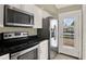 Functional kitchen with stainless steel appliances, granite countertops, and convenient access to the outside at 3249 Sandy Shore Ln, Kissimmee, FL 34743