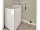 The laundry area has a washer and a tile floor, offering utility and practicality at 3249 Sandy Shore Ln, Kissimmee, FL 34743