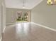 Open living room with tile floors and sliding glass doors leading to the outside at 3249 Sandy Shore Ln, Kissimmee, FL 34743