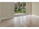 Living room with tile floors and sliding glass doors leading to the patio at 3249 Sandy Shore Ln, Kissimmee, FL 34743