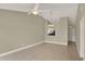 Spacious living room features tile flooring, a ceiling fan, and an open layout perfect for modern living at 3249 Sandy Shore Ln, Kissimmee, FL 34743