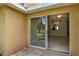 The patio area offers a view into a living space and of trees, creating an inviting indoor-outdoor experience at 3249 Sandy Shore Ln, Kissimmee, FL 34743