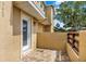 Private outdoor patio with tiled flooring and a secure enclosure, and neutral exterior at 3249 Sandy Shore Ln, Kissimmee, FL 34743