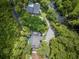 Aerial view of the beautiful home featuring a large pool and surrounding waterways at 33 Eastwind Ln, Maitland, FL 32751
