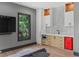 Stylish bar area featuring custom cabinetry, modern appliances, sleek countertop, and a red SMEG refrigerator at 33 Eastwind Ln, Maitland, FL 32751