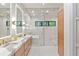 Bright bathroom with double vanity, modern fixtures, glass-enclosed shower, and marble-look tiling at 33 Eastwind Ln, Maitland, FL 32751