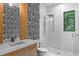 Contemporary bathroom with geometric tile accent wall, glass-enclosed shower, and modern vanity at 33 Eastwind Ln, Maitland, FL 32751