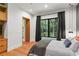 Comfortable bedroom with hardwood floors, large windows, and natural light with access to an adjoining bath at 33 Eastwind Ln, Maitland, FL 32751
