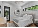 Cozy bedroom with a queen bed, modern decor, large windows with backyard views, and hardwood floors at 33 Eastwind Ln, Maitland, FL 32751