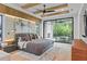 Luxurious bedroom featuring a plush bed, wooden beamed ceiling, and sliding glass doors to an outdoor patio at 33 Eastwind Ln, Maitland, FL 32751