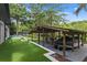 Beautiful boat dock with covered boat lift, putting green and lovely landscaping at 33 Eastwind Ln, Maitland, FL 32751