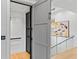 Indoor elevator in a modern home, complemented by an open staircase with glass railings and contemporary lighting at 33 Eastwind Ln, Maitland, FL 32751