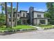 Modern home with gray stucco, black trim, and manicured landscaping for curb appeal at 33 Eastwind Ln, Maitland, FL 32751