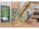 Bright foyer featuring hardwood floors, glass staircase, and modern design elements at 33 Eastwind Ln, Maitland, FL 32751
