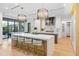 Gourmet kitchen with white cabinets, stainless appliances, and large island seating at 33 Eastwind Ln, Maitland, FL 32751