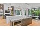 Spacious modern kitchen with a large island, stainless steel appliances, marble countertops, and oversized windows at 33 Eastwind Ln, Maitland, FL 32751