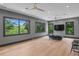 Spacious living room with hardwood floors, large windows providing scenic views, and contemporary furniture at 33 Eastwind Ln, Maitland, FL 32751