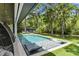 Stunning backyard pool with modern lounge chairs, and lush green landscaping at 33 Eastwind Ln, Maitland, FL 32751
