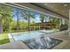 Stunning pool area with covered boat dock, lounge chairs, and lush natural surroundings, perfect for relaxation at 33 Eastwind Ln, Maitland, FL 32751