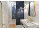 Chic powder room featuring unique wallpaper, marble sink, and modern fixtures at 33 Eastwind Ln, Maitland, FL 32751