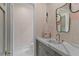 Elegant powder room with marble countertop, stylish mirror, neutral wallpaper, and sleek fixtures at 33 Eastwind Ln, Maitland, FL 32751