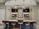 Stylish bar with pendant lights, modern chairs and TV's at 3371 Yellowtop Loop, Clermont, FL 34714