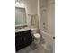 Well-lit bathroom features a vanity with granite countertop, toilet, and a shower over tub at 3371 Yellowtop Loop, Clermont, FL 34714