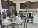 Open concept kitchen and dining area with stainless appliances and ample cabinet space at 3371 Yellowtop Loop, Clermont, FL 34714