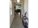 Welcoming foyer featuring neutral tile flooring, console table, and open view to the living area at 3371 Yellowtop Loop, Clermont, FL 34714