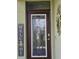 Stylish front door with decorative glass panel and modern hardware at 3371 Yellowtop Loop, Clermont, FL 34714