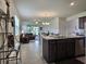 Stylish kitchen with granite countertops, stainless steel appliances, and a seamless flow to the living area at 3371 Yellowtop Loop, Clermont, FL 34714